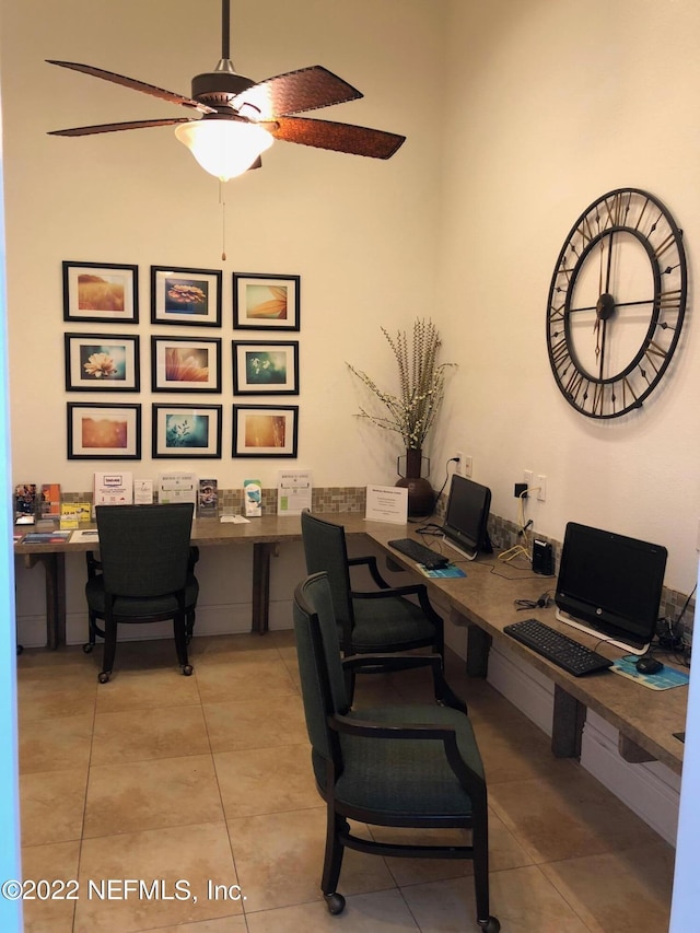 home office featuring ceiling fan, built in desk, and light tile patterned floors