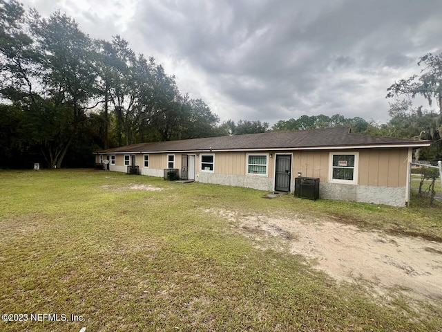 view of front of home featuring a front lawn and central AC unit