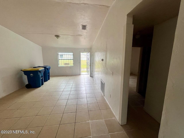 hallway featuring light tile patterned floors