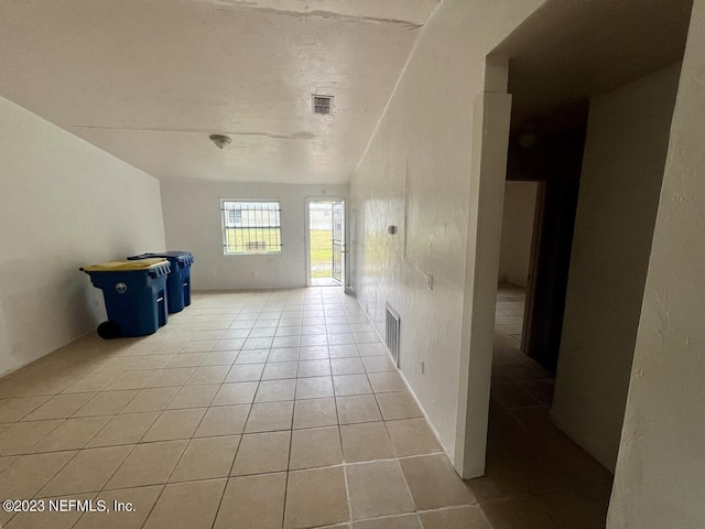 interior space featuring light tile patterned flooring and visible vents