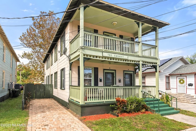 view of front of house with a balcony and covered porch