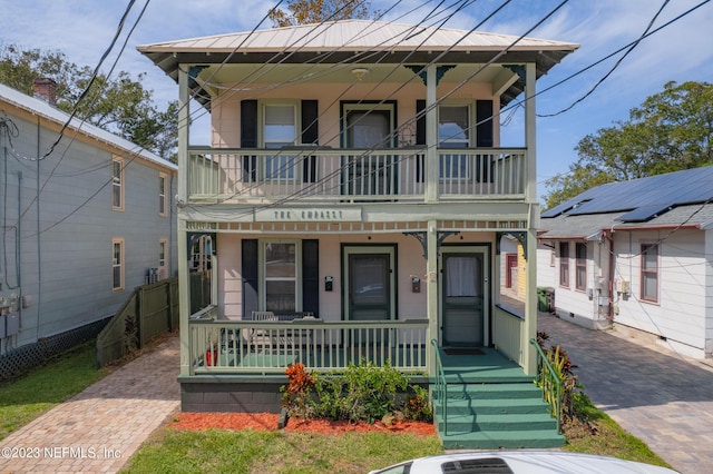 view of front of house featuring covered porch and a balcony