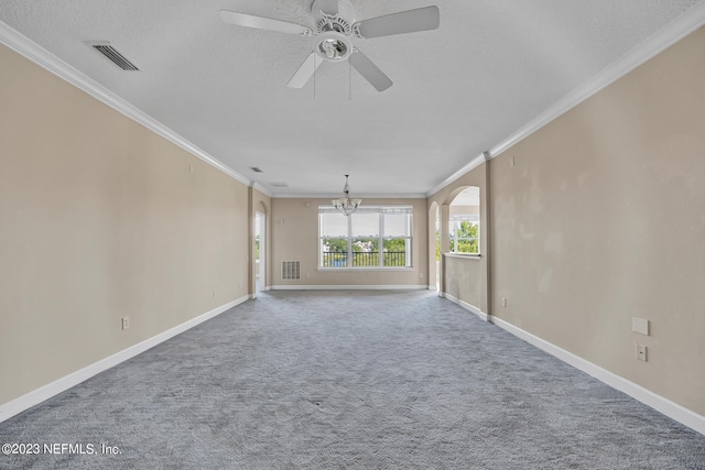 spare room featuring a textured ceiling, ceiling fan with notable chandelier, crown molding, and carpet flooring