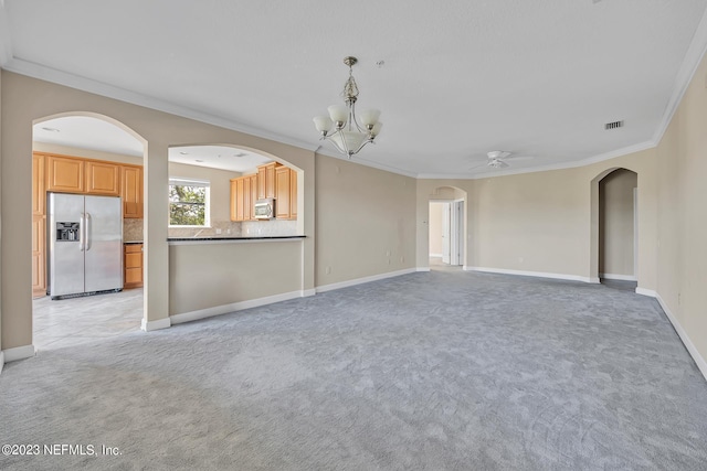 unfurnished living room featuring light carpet, ceiling fan with notable chandelier, and crown molding