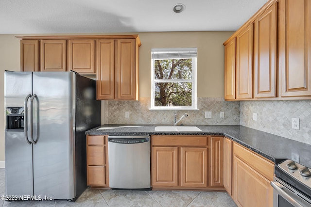 kitchen featuring stainless steel appliances, sink, light tile flooring, and backsplash