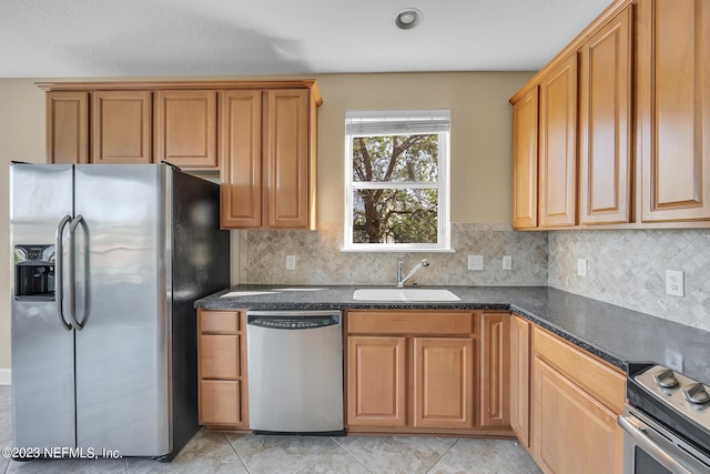 kitchen featuring light tile patterned floors, stainless steel appliances, tasteful backsplash, and a sink