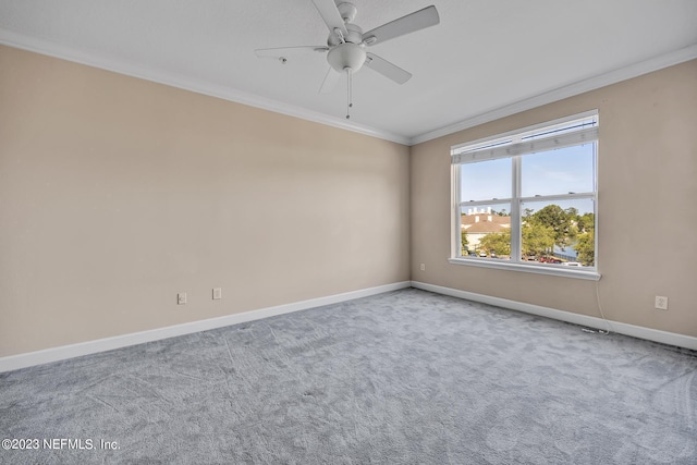 carpeted empty room with ceiling fan and crown molding