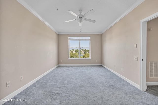 empty room featuring light carpet, baseboards, visible vents, and crown molding