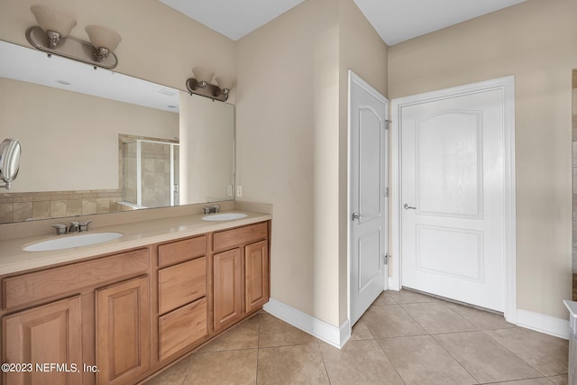 bathroom with tile floors, double sink, and vanity with extensive cabinet space