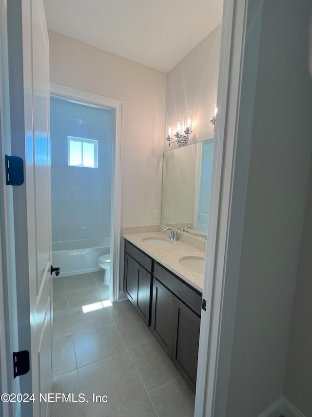 full bath with bathing tub / shower combination, double vanity, toilet, a sink, and tile patterned flooring