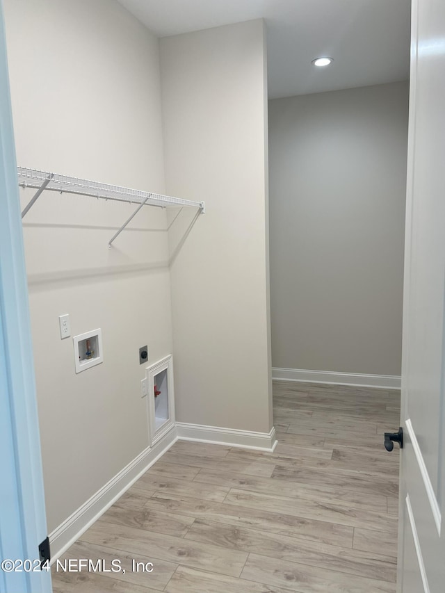 washroom with washer hookup, light wood-type flooring, and hookup for an electric dryer