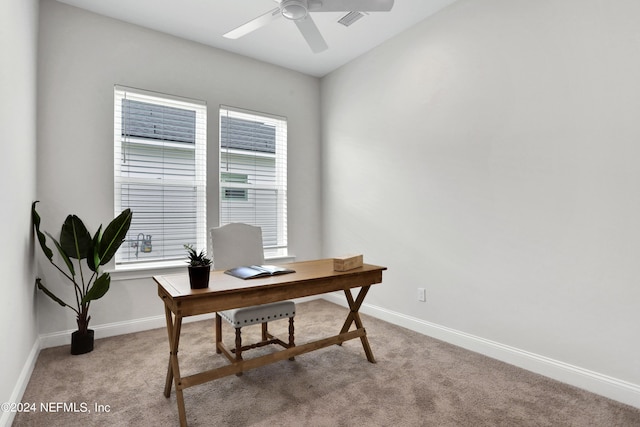 office featuring light carpet, ceiling fan, and baseboards