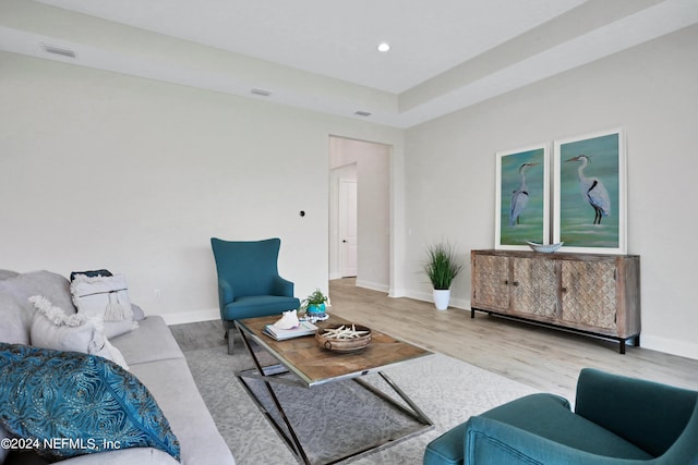 living area with light wood-style flooring, visible vents, baseboards, and recessed lighting