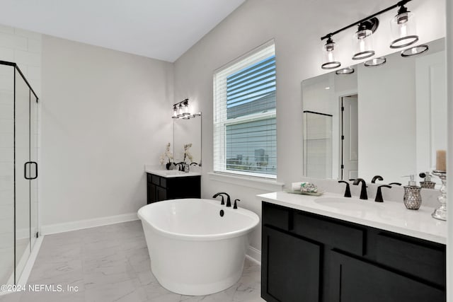 bathroom featuring vanity, a healthy amount of sunlight, and shower with separate bathtub