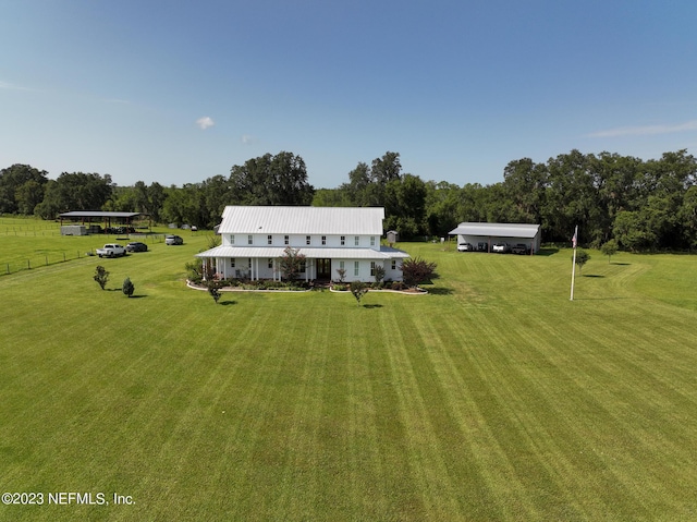 view of front of home with a front yard and fence