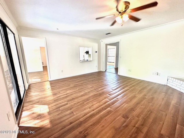 empty room featuring wood-type flooring, ceiling fan, and crown molding