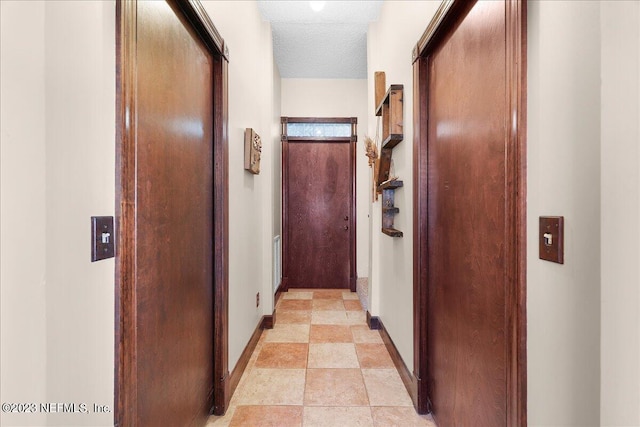 corridor featuring a textured ceiling