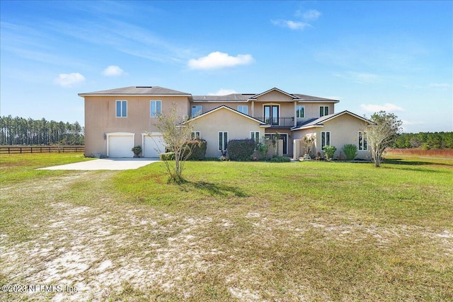 view of front of property with a front lawn, a balcony, and a garage