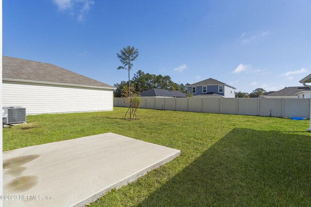 view of yard with cooling unit and a patio