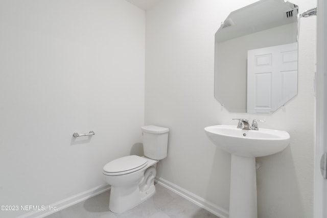 bathroom featuring tile patterned floors and toilet