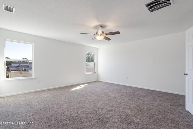 unfurnished room featuring carpet, ceiling fan, and a textured ceiling