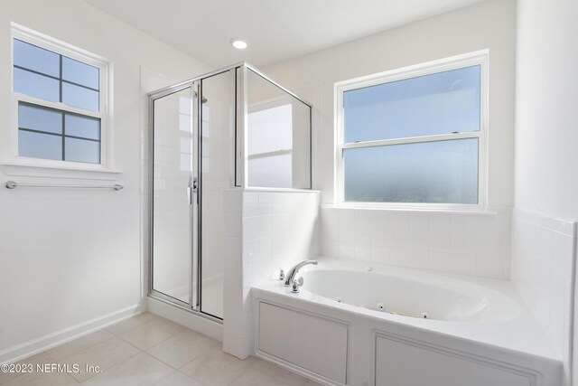 bathroom featuring shower with separate bathtub and tile patterned flooring