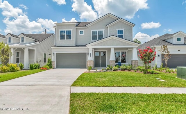 craftsman inspired home featuring driveway, an attached garage, a front lawn, and brick siding