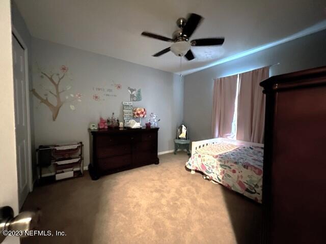 bedroom with ceiling fan and carpet floors