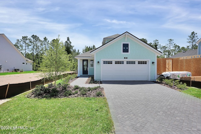 view of front of house with a garage and a front yard