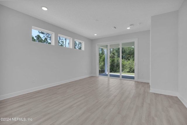 spare room featuring light wood-type flooring