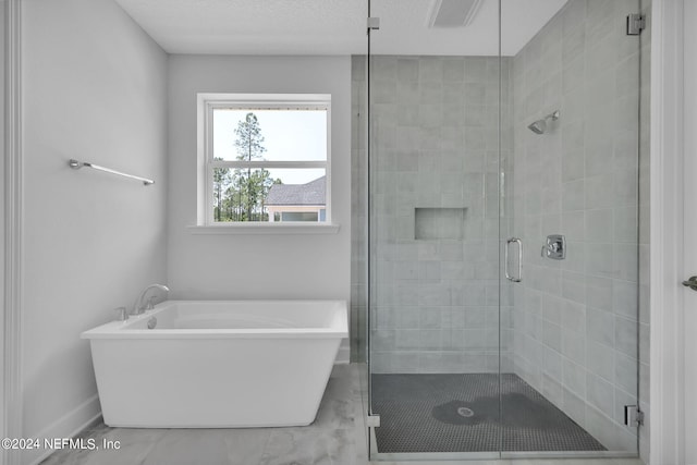 bathroom with a textured ceiling and plus walk in shower