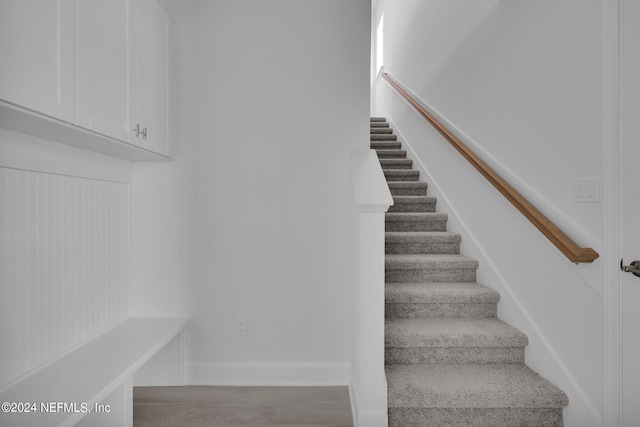 staircase featuring hardwood / wood-style flooring