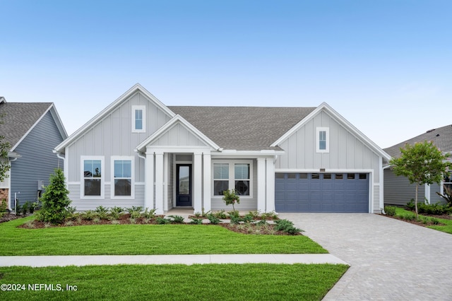 view of front of home featuring a garage and a front yard