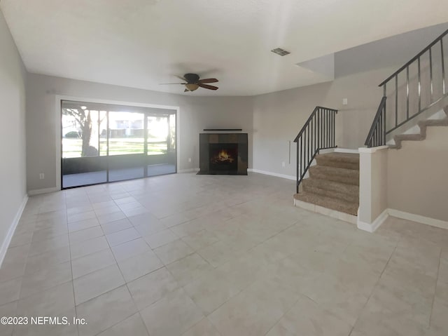 unfurnished living room with light tile patterned floors and ceiling fan