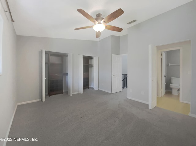 unfurnished bedroom with light carpet, ensuite bath, and ceiling fan