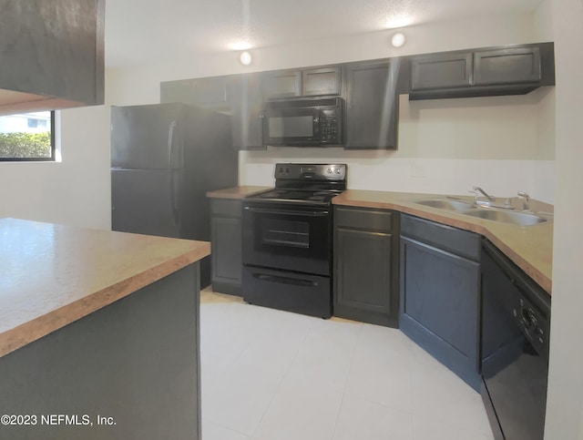 kitchen featuring black appliances, gray cabinetry, and sink