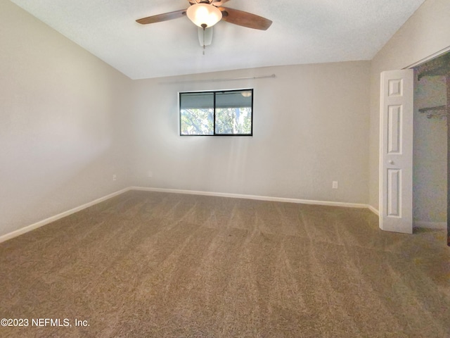 unfurnished bedroom with carpet, ceiling fan, and lofted ceiling