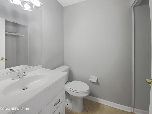 bathroom featuring tile patterned flooring, vanity, and toilet