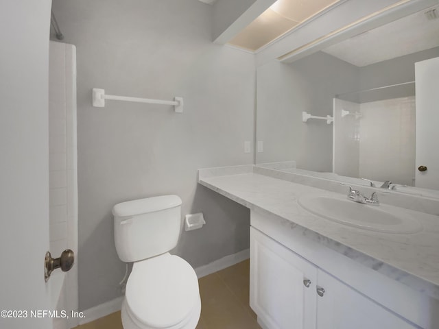 bathroom with a shower, vanity, toilet, and tile patterned flooring