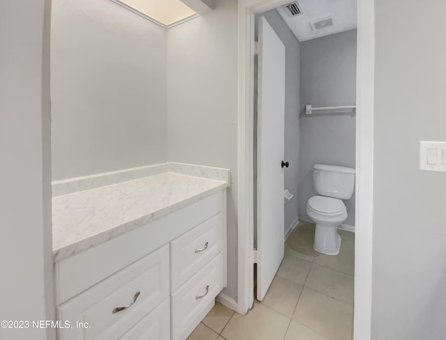 bathroom featuring toilet, vanity, and tile patterned floors