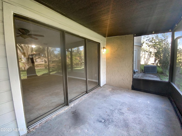 unfurnished sunroom featuring ceiling fan and wooden ceiling