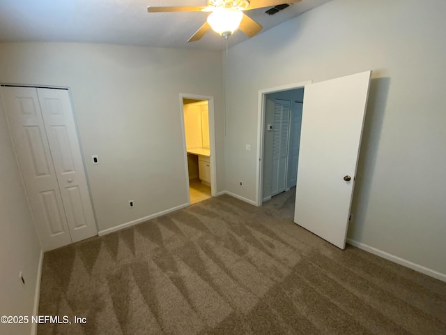 unfurnished bedroom with lofted ceiling, visible vents, carpet flooring, ceiling fan, and baseboards