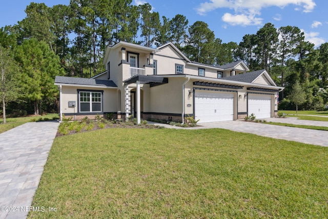 view of front of home with a balcony and a front lawn