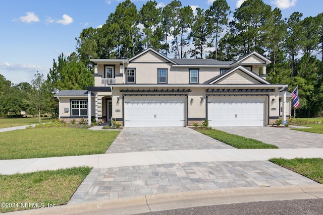 view of front of property with a garage and a front lawn