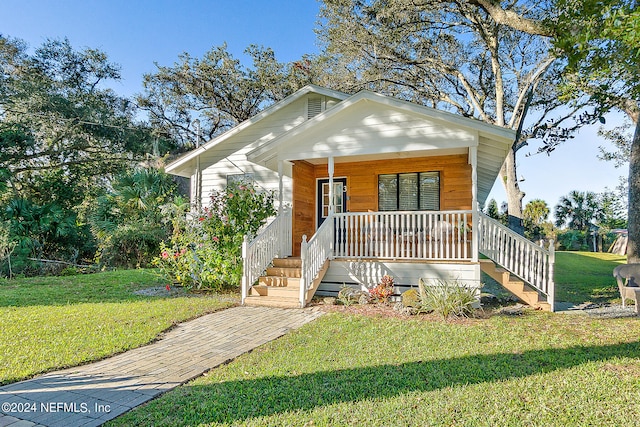 view of front of home with a porch and a front yard