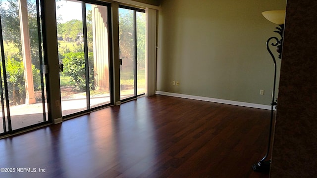 7602 Las Palmas Way Unit 181, Jacksonville, FL 32256 - unfurnished room with baseboards and dark wood finished floors