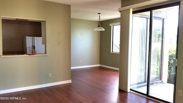 7602 Las Palmas Way Unit 181, Jacksonville, FL 32256 - spare room with dark wood-type flooring and baseboards