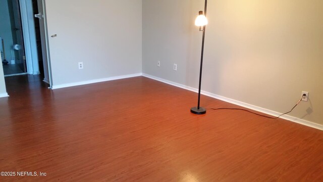 7602 Las Palmas Way Unit 181, Jacksonville, FL 32256 - empty room with dark wood-style flooring and baseboards