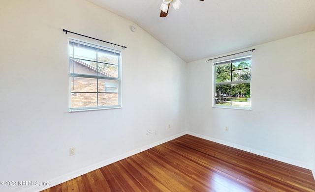 empty room with hardwood / wood-style flooring, vaulted ceiling, and ceiling fan