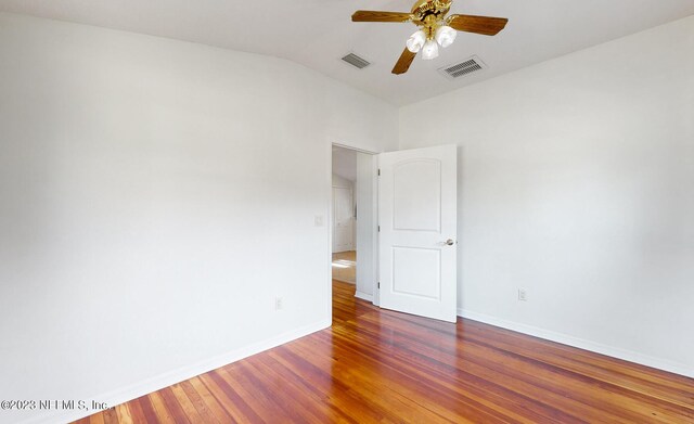 unfurnished room with ceiling fan, hardwood / wood-style floors, and lofted ceiling